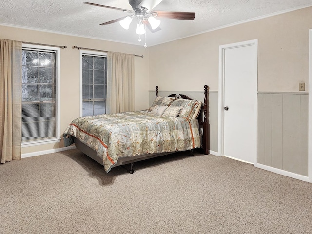 906 Richardson Dr, Jasper, TX 75951 - bedroom featuring a textured ceiling, carpet, ornamental molding, ceiling fan, and a wainscoted wall