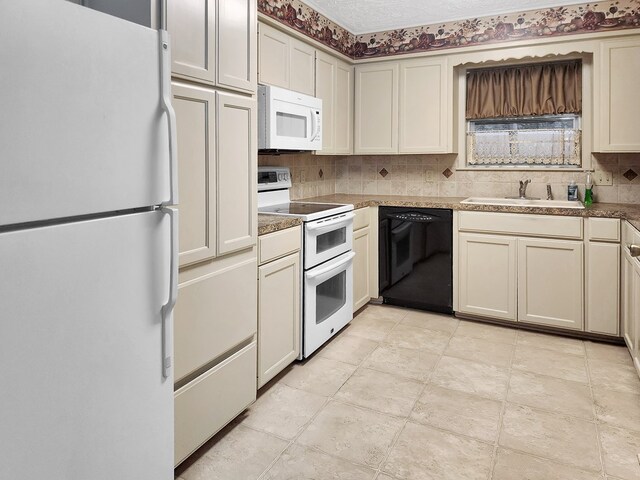 906 Richardson Dr, Jasper, TX 75951 - kitchen with white appliances, backsplash, and cream cabinetry