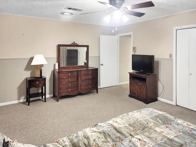 906 Richardson Dr, Jasper, TX 75951 - bedroom with a textured ceiling, light colored carpet, wainscoting, crown molding, and a ceiling fan
