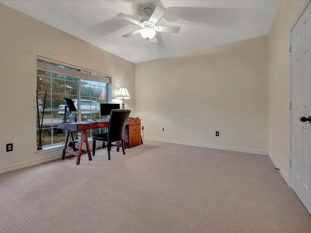 carpeted office space featuring ceiling fan