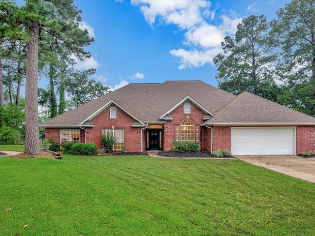 view of front of house featuring a front yard and a garage