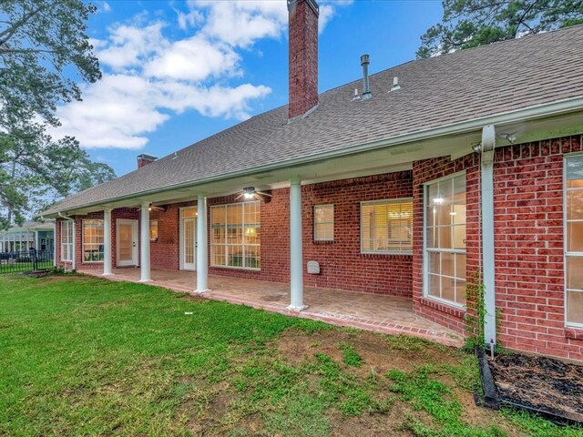 rear view of house with a lawn and a patio area