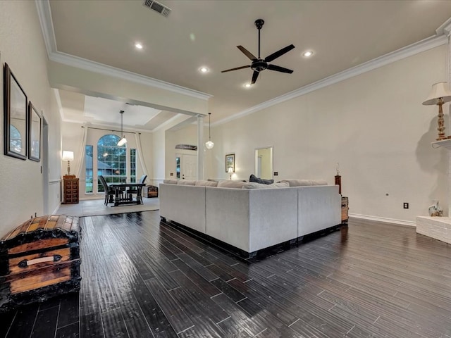 living room featuring ceiling fan, dark hardwood / wood-style floors, and ornamental molding