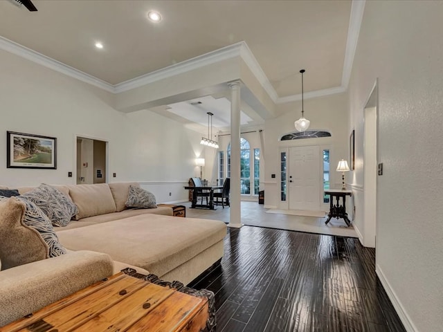 living room with dark hardwood / wood-style flooring and ornamental molding