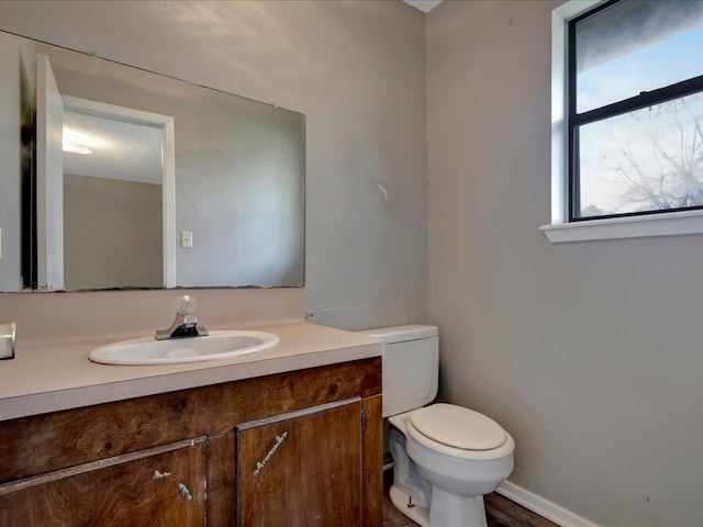 bathroom featuring toilet and vanity