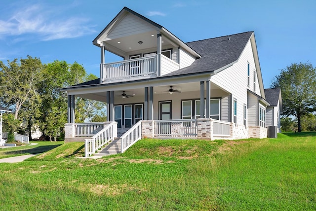 view of front of property with ceiling fan, a front yard, central air condition unit, a balcony, and a porch