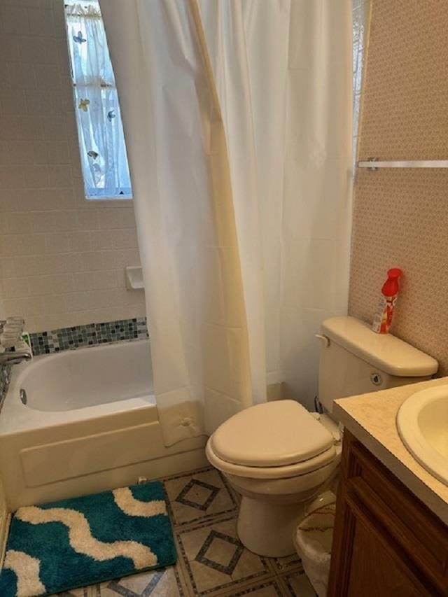 full bathroom with vanity, toilet, and shower / tub combo