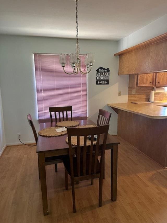 dining room featuring hardwood / wood-style floors and a notable chandelier