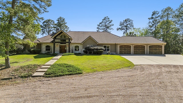 225 Mcgregor Dr, Brookeland, TX 75931 - view of front of property with an attached garage, stone siding, a tile roof, concrete driveway, and a front yard