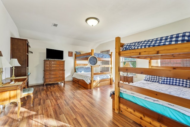 225 Mcgregor Dr, Brookeland, TX 75931 - bedroom featuring lofted ceiling, baseboards, visible vents, and wood finished floors
