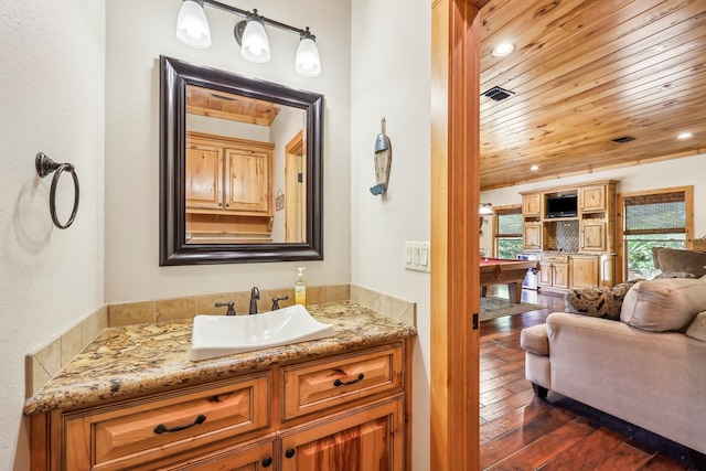 225 Mcgregor Dr, Brookeland, TX 75931 - bathroom with hardwood / wood-style floors, vanity, visible vents, recessed lighting, and wood ceiling