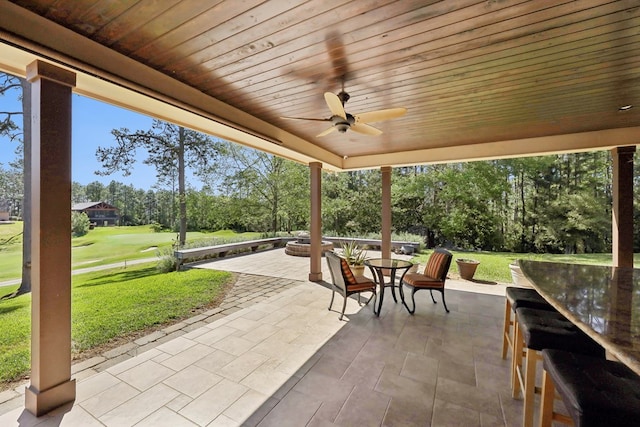 225 Mcgregor Dr, Brookeland, TX 75931 - view of patio / terrace featuring outdoor dining area, golf course view, and a ceiling fan