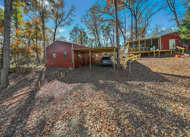 back of property featuring an outdoor structure and a carport