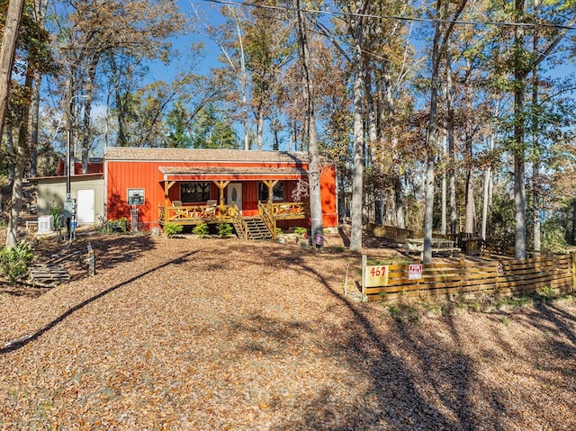 rear view of property featuring a deck