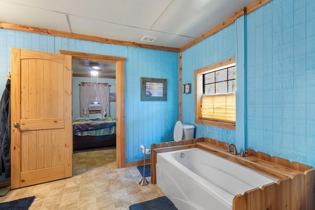 bathroom featuring toilet and a bath