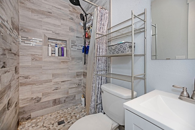 bathroom with curtained shower, vanity, and toilet