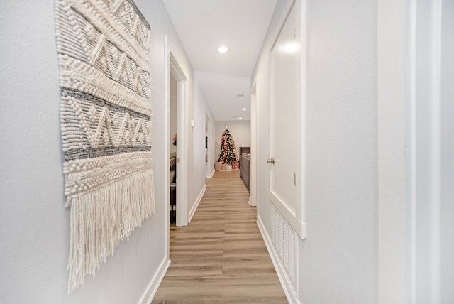 corridor with light hardwood / wood-style flooring