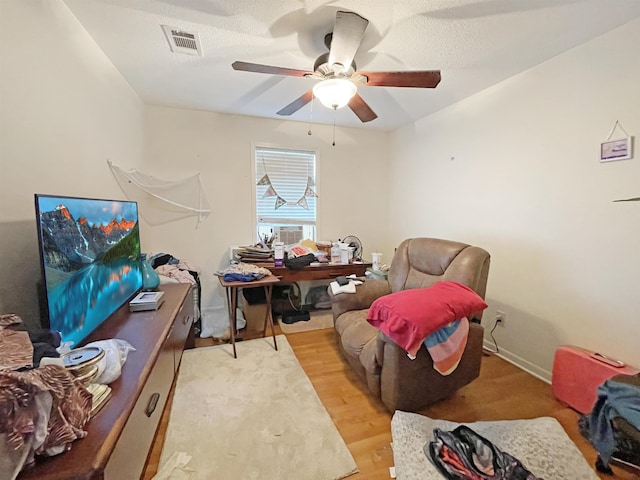 office featuring light wood-type flooring and ceiling fan