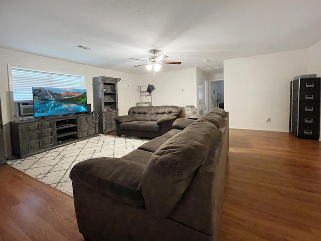 living room with ceiling fan and wood-type flooring