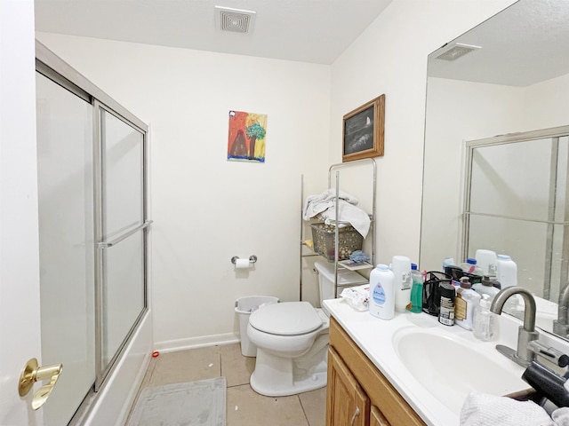 full bathroom with tile patterned flooring, vanity, toilet, and enclosed tub / shower combo