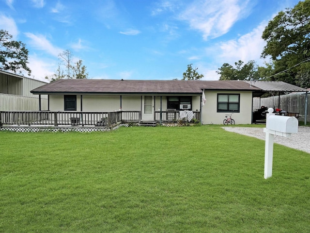 rear view of property featuring a lawn