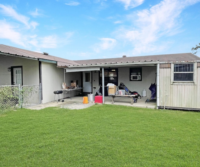 rear view of house featuring a patio and a lawn