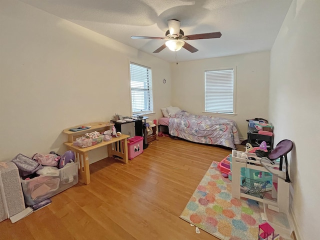 bedroom with ceiling fan and hardwood / wood-style flooring