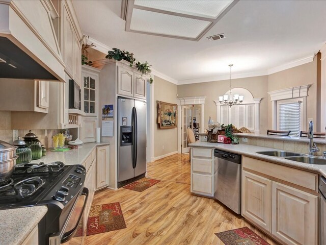 kitchen with custom exhaust hood, visible vents, appliances with stainless steel finishes, ornamental molding, and a sink
