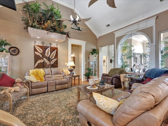 living area featuring visible vents, ceiling fan, wood finished floors, crown molding, and high vaulted ceiling