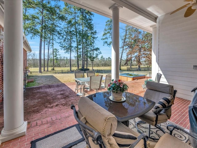 view of patio / terrace with a ceiling fan, outdoor dining space, and fence