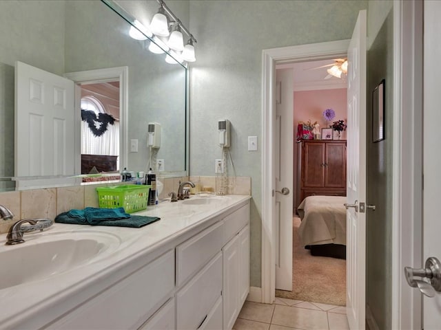 bathroom with double vanity, tile patterned flooring, a sink, and ensuite bathroom