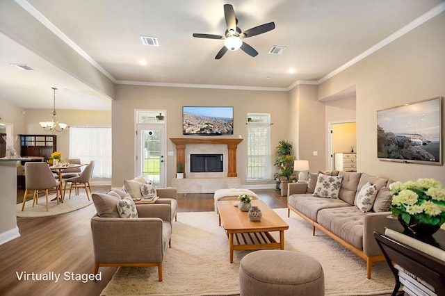 113 Westfield Loop, Lufkin, TX 75904 - living room with a chandelier, plenty of natural light, a ceiling fan, wood finished floors, and ornamental molding