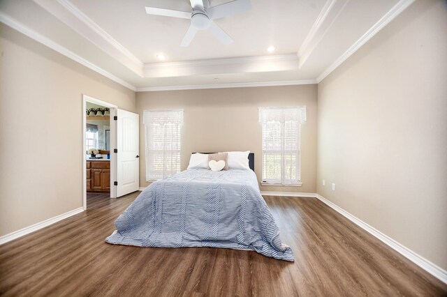 113 Westfield Loop, Lufkin, TX 75904 - bedroom with wood finished floors, multiple windows, a tray ceiling, and ornamental molding