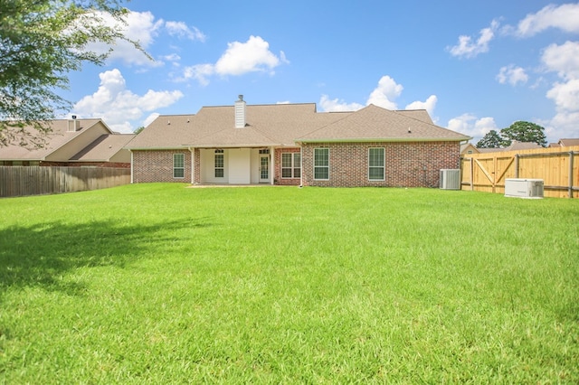 113 Westfield Loop, Lufkin, TX 75904 - rear view of house with a fenced backyard, brick siding, and a chimney