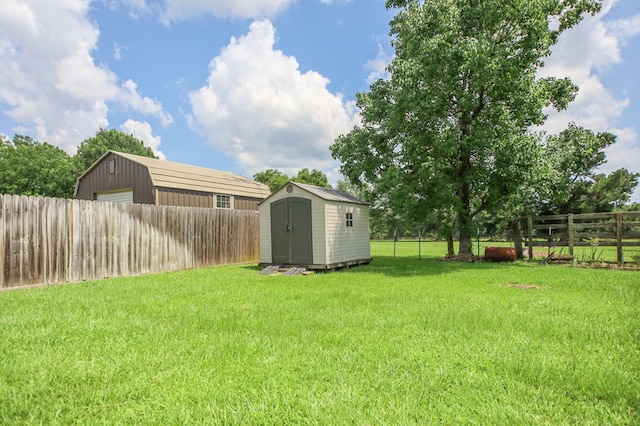 113 Westfield Loop, Lufkin, TX 75904 - fenced backyard featuring a storage unit and a detached garage
