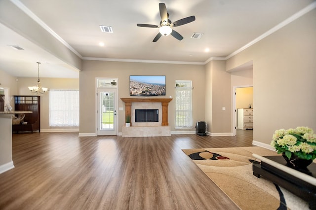 113 Westfield Loop, Lufkin, TX 75904 - living room featuring a chandelier, a glass covered fireplace, wood finished floors, crown molding, and a ceiling fan