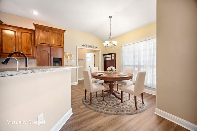 113 Westfield Loop, Lufkin, TX 75904 - dining area with a chandelier, wood finished floors, and lofted ceiling