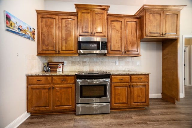 113 Westfield Loop, Lufkin, TX 75904 - kitchen with appliances with stainless steel finishes, light stone countertops, and brown cabinets