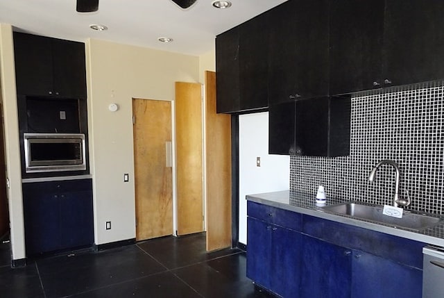 330 Bostwick St, Nacogdoches, TX 75965 - kitchen featuring stainless steel microwave, decorative backsplash, dark cabinets, and recessed lighting