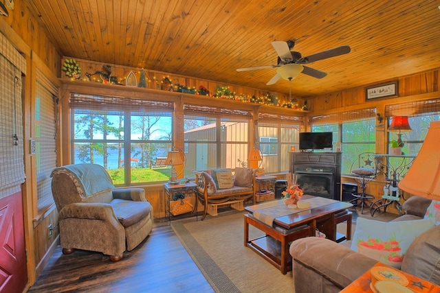 2105 Carters Ferry Rd, E Road, Milam, TX 75959 - living area with wood walls, plenty of natural light, a ceiling fan, and wood finished floors