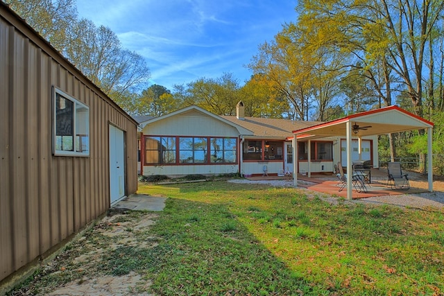 2105 Carters Ferry Rd, E Road, Milam, TX 75959 - rear view of property featuring a sunroom, a yard, a patio area, fence, and a chimney