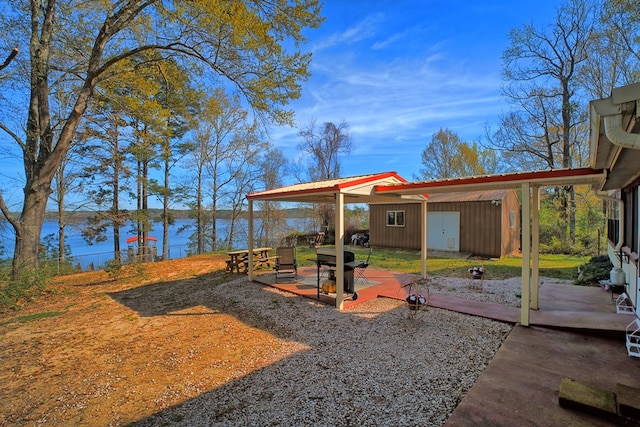 2105 Carters Ferry Rd, E Road, Milam, TX 75959 - view of yard featuring a water view, a patio area, and an outdoor structure