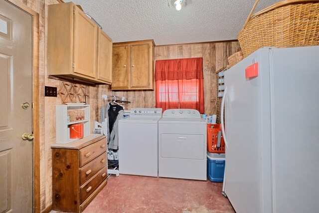 2105 Carters Ferry Rd, E Road, Milam, TX 75959 - laundry area with cabinet space, wood walls, washing machine and clothes dryer, and a textured ceiling