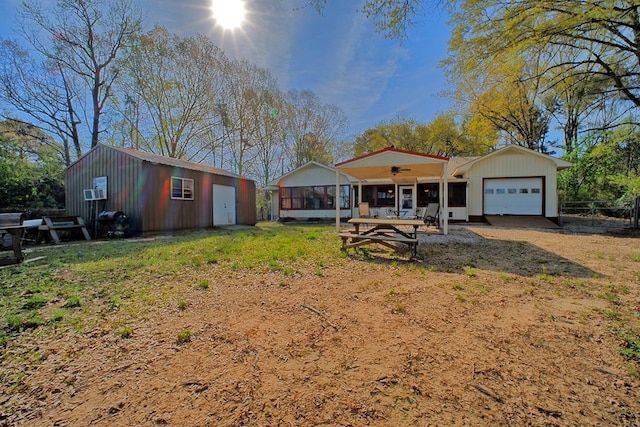 2105 Carters Ferry Rd, E Road, Milam, TX 75959 - exterior space featuring a garage, fence, a ceiling fan, and an outdoor structure