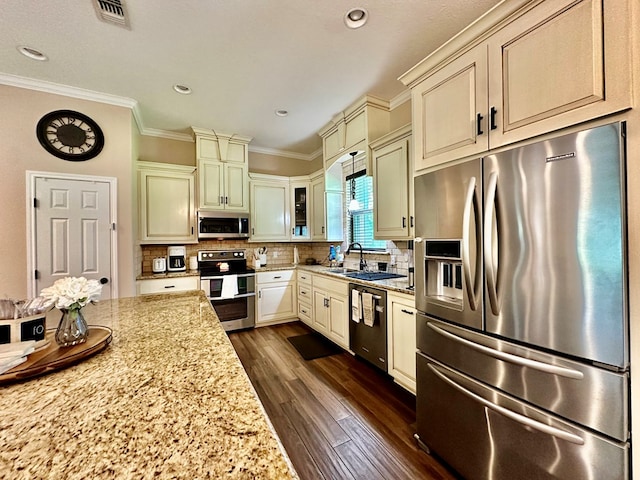 4815 Fm 2827, Warren, TX 77664 - kitchen featuring stainless steel appliances, cream cabinetry, light stone countertops, dark wood-style flooring, and crown molding