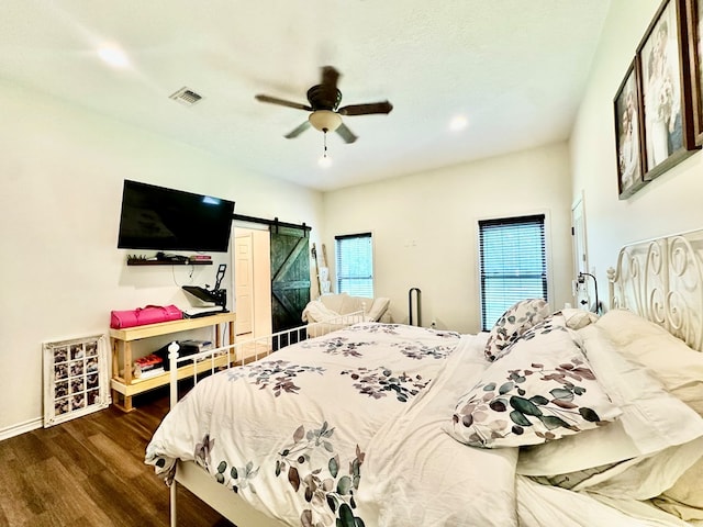 4815 Fm 2827, Warren, TX 77664 - bedroom featuring wood finished floors, a barn door, ceiling fan, recessed lighting, and baseboards
