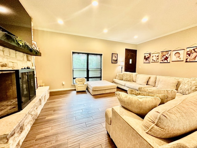 4815 Fm 2827, Warren, TX 77664 - living room with wood finished floors, a stone fireplace, crown molding, recessed lighting, and baseboards