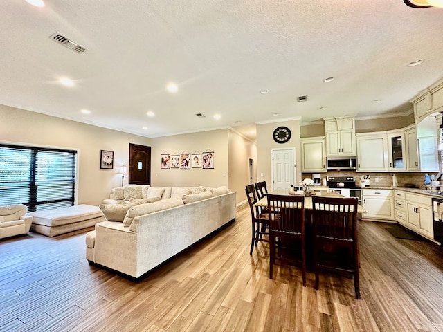4815 Fm 2827, Warren, TX 77664 - living area featuring ornamental molding, dark wood-style flooring, recessed lighting, a textured ceiling, and baseboards