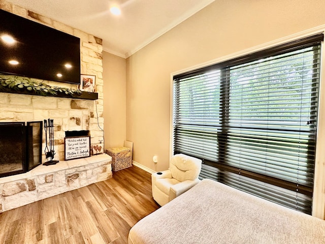 4815 Fm 2827, Warren, TX 77664 - bedroom featuring a stone fireplace, crown molding, wood finished floors, and baseboards