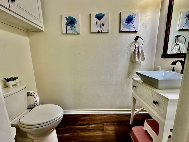 4815 Fm 2827, Warren, TX 77664 - half bath with wood finished floors, baseboards, vanity, and toilet